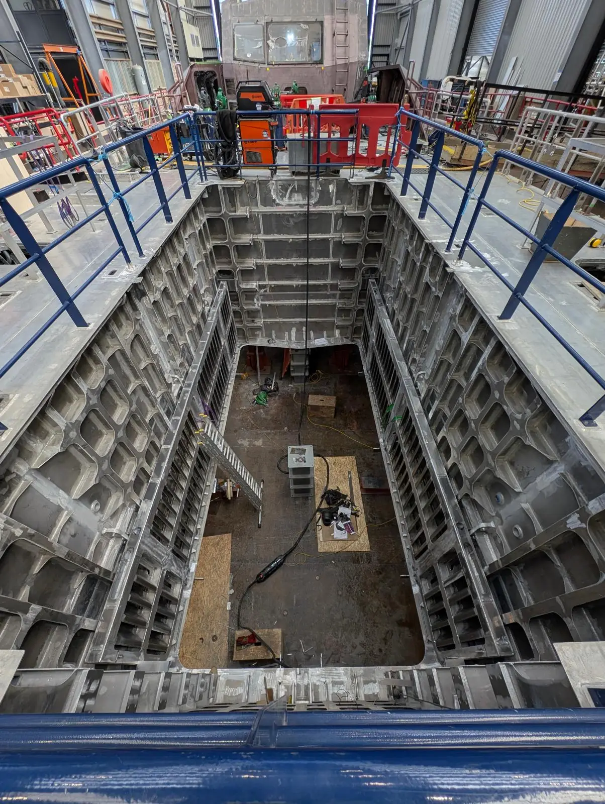 Moonpool trunk of an offshore vessel under construction, seen from the deck above